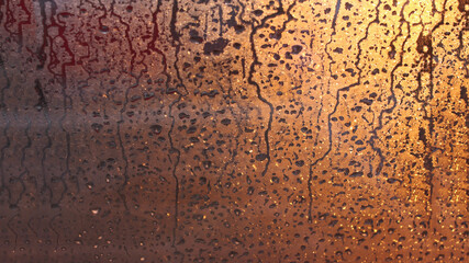 Natural background of condensation, drops of flowing water on the window pane
