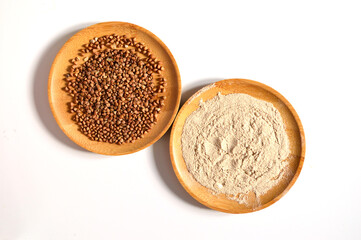 Buckwheat groats and buckwheat flour on a white background