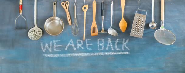 reopen sign, restaurant or cafe ready to service after corona lockdown, kitchen utensils and...