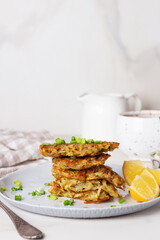 Stack of potato pancakes or draniki with sour cream