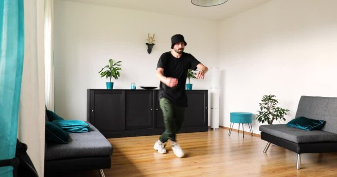 man is dacing in a living room