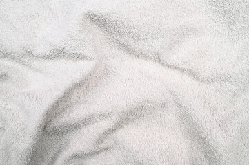 Fototapeta na wymiar Fuzzy wrinkled white fabric, close up