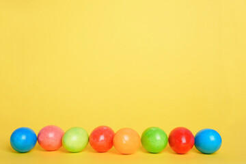 painted colorful eggs for the Easter holiday yellow background. background for the poster