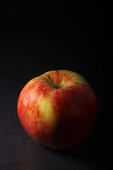 An apple against black background