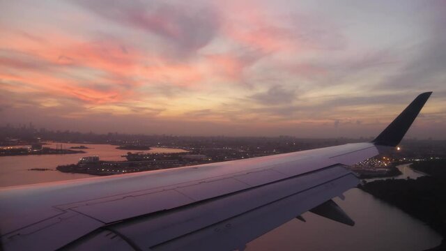 Plane landing in New York at beautiful sunset