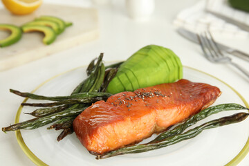 Tasty cooked salmon and vegetables served on white table, closeup. Healthy meals from air fryer