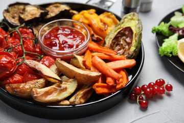Tasty cooked vegetables served on grey table, closeup. Healthy meals from air fryer