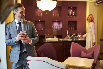 Copy-space photo of lovely couple on different sides of room