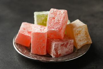 Turkish delight dessert on dark table, closeup