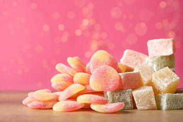 Pile of tasty sweets on wooden table, closeup. Space for text