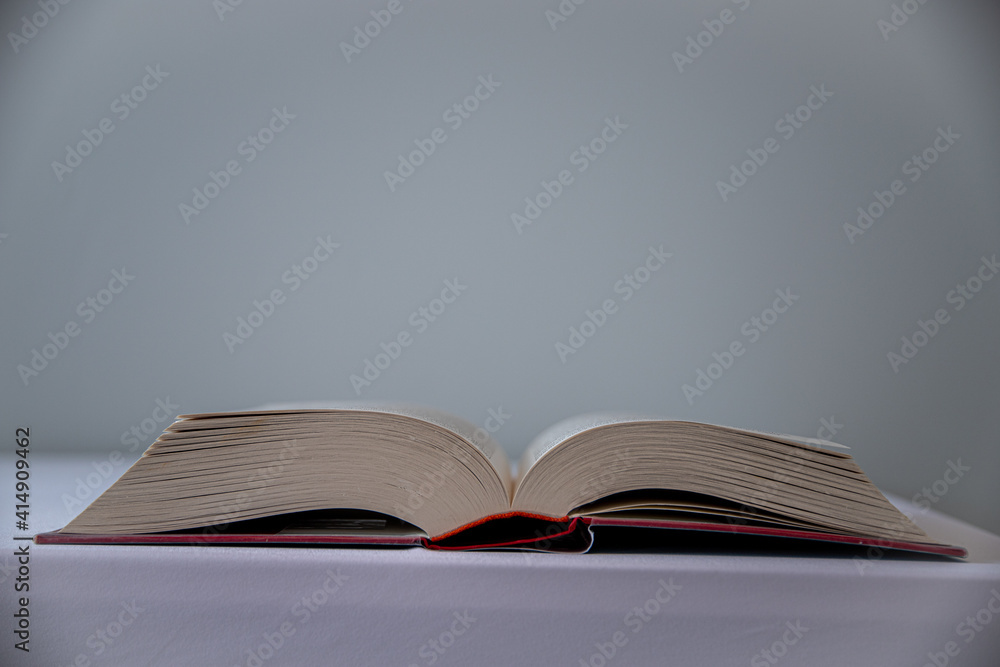 Poster closeup shot of an open book on a table