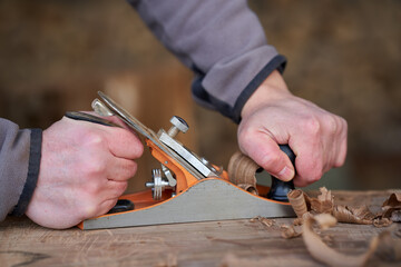 Carpenter working with planer