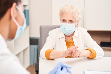 Physician consulting woman patient, while giving recommendations