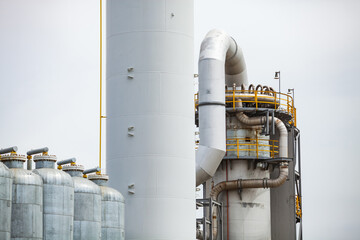 White and galvanized tanks on grey sky background. Oil refinery plant (refining complex). Abstract...