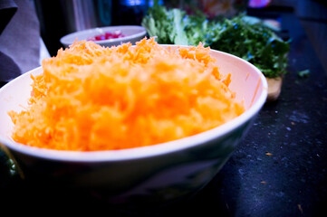 Bowl full of fresh grated carrot
