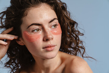 Beautiful half-naked nice girl posing with eye patches