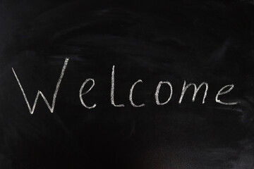 Obraz premium welcome word in chalk on a blackboard