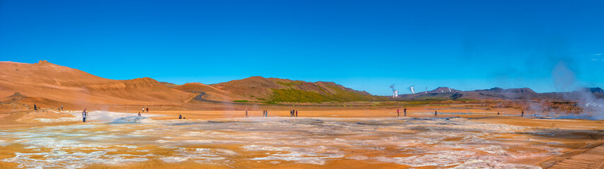 Panoramic view over colorful geothermal active zone Hverir near Myvatn lake in Iceland, resembling Martian red planet landscape, at summer and blue sky