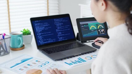 Back rear view of young asian woman, freelance data scientist work remotely at home coding programing on Big data mining, AI data engineering, IT Technician Works on Artificial Intelligence Project. - Powered by Adobe