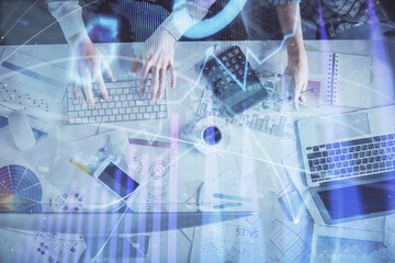 Double exposure of man and woman working together and financial chart hologram drawing. market analysis concept. Computer background. Top View.