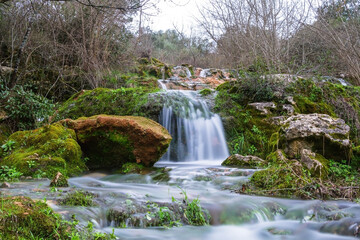 Waterfall in the forest of Beselga de Cima, Portugal. River waterfall with moss covered stones and rocks