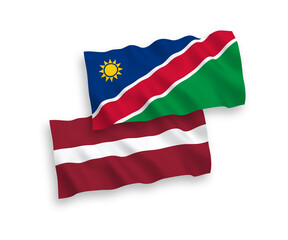 National vector fabric wave flags of Latvia and Republic of Namibia isolated on white background. 1 to 2 proportion.