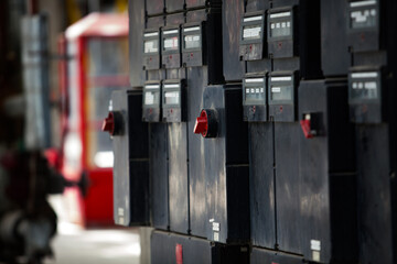 Oil refinery plant. Black electric console. Red switchers. Close-up. Low depth-of-field. Sunny day.