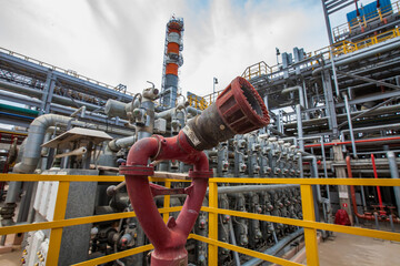 Oil refinery plant safety technologies. Fire extinguisher system. Distillation tower and pipelines...
