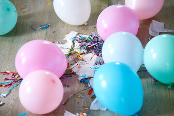 The mess after the birthday celebration with balloons and confetti on the floor, After party chaos, Messy room..