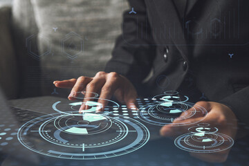 Woman typing the keyboard to create innovative software to change the world and provide a completely new service. Close up shot. Hologram tech graphs. Concept of Dev team. Formal wear.