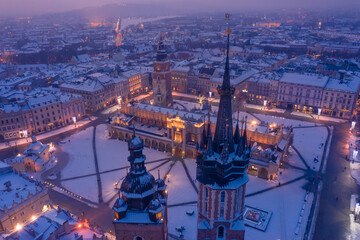 Towers and spires of St. Mary's Basilica Gothic church at Krakow Poland old town main city square in winter.