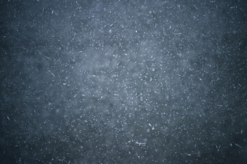 White crystals of frost on the ice with frozen bubbles of water. Background