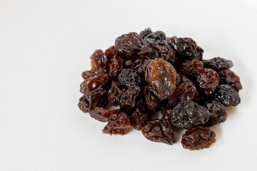Dried raisins on white background