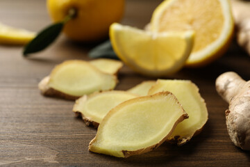 Cut ginger and lemon on wooden table, closeup