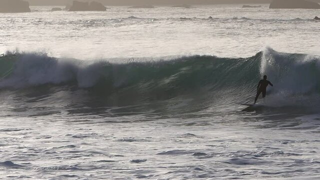 Surfer in Gran Canaria island beach el rincon on back light