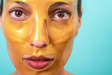Beautiful woman using facial collagen gel skincare mask treatment