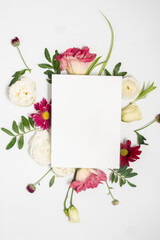 Floral arrangement and blank card on a white background. Mothers day and international womens day concept. Floral frame and Copy space. 
