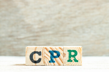 Alphabet letter block in word CPR (abbreviation of Cardiopulmonary resuscitation) on wood background