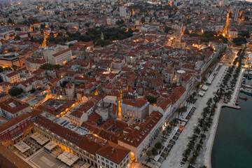 Aerial drone shot of Diocletian Palace at dusk in Split old town with lights before sunrise in Croatia