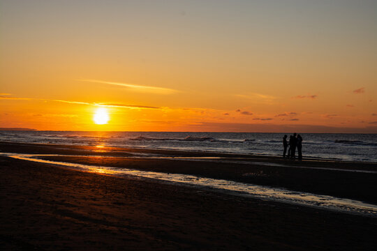 People Chatting And Hanging Around On The Beach Sunset Before Sunset