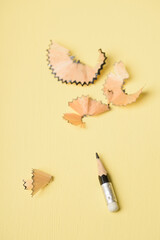 Conceptual image of idea creative thinking and innovation business strategy. Small black pencil on yellow background.