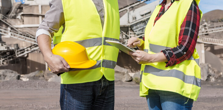 Engineers with tablet having meeting on industrial facility