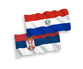 Fototapeta premium National vector fabric wave flags of Paraguay and Serbia isolated on white background. 1 to 2 proportion.