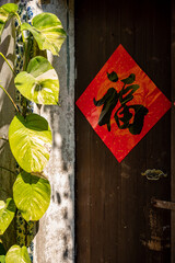 A red door poster with a Chinese word with means "good luck".