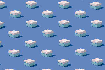 Creative isometric pattern made of gift boxes on pastel blue background. Minimal concept. Wallpaper, banner.