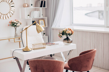 female office with a workspace desk in a light modern style with white furniture with laptop on table