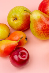 Pears,apricot, cherries on pink background