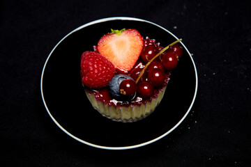 beautiful and tasty looking cheesecake on a black background 
