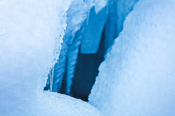 Obraz na płótnie Canvas Little hole in the snow and stalactites near Brúarárfoss Waterfall, Iceland, North Atlantic Ocean