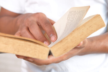 close up of person hand reading a book